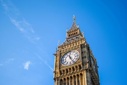 Photograph of the Queen Elizabeth Tower, London's iconic clock tower also nicknamed Big Ben. The backdrop is a clear blue sky.