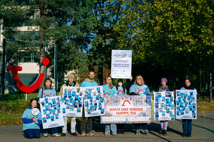 NGO staff outside of TUI HQ holding placards