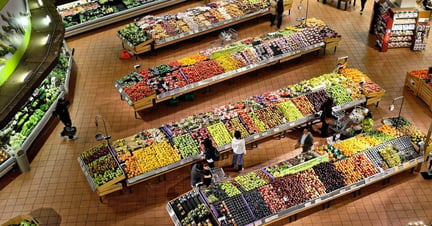 An aerial shot of the produce section of a supermarket.