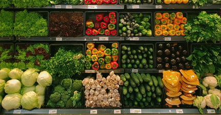 Supermarket shelves full of veg