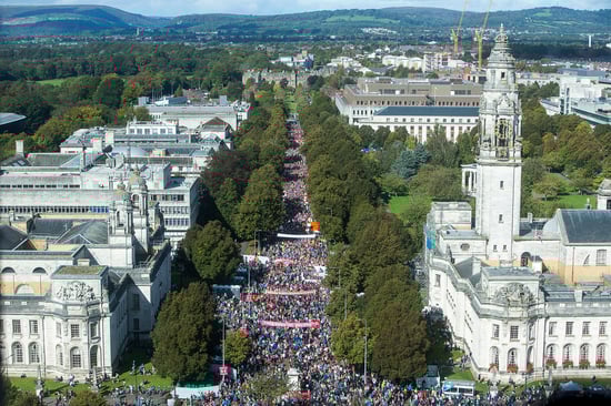A vibrant crowd of people fills one of the main streets in Cardiff.