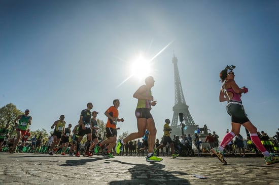 Marathon runners pass by the Eiffel Tower in Paris.