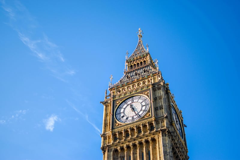 Photograph of the Queen Elizabeth Tower, London's iconic clock tower also nicknamed Big Ben. The backdrop is a clear blue sky.